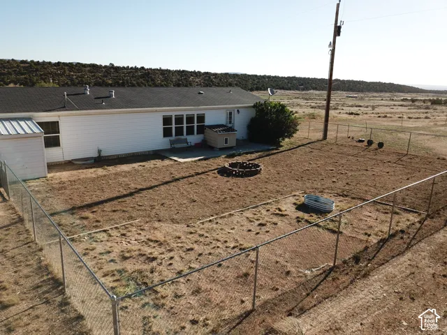 Expansive fenced yard with a concrete patio
