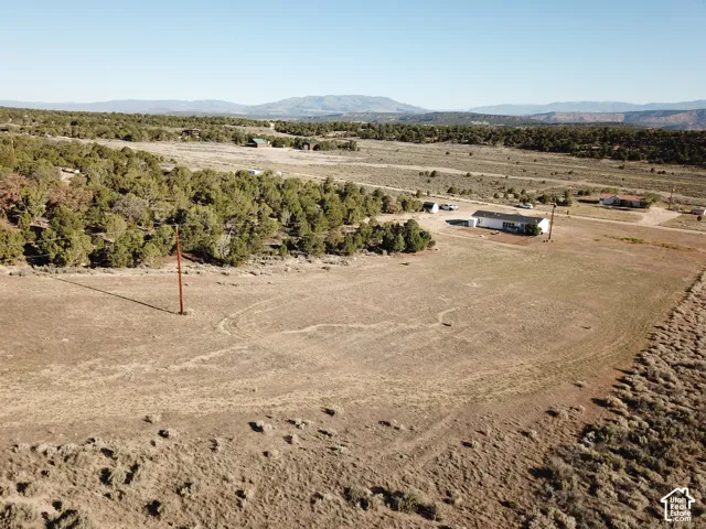 Expansive undeveloped land featuring natural terrain and distant mountains