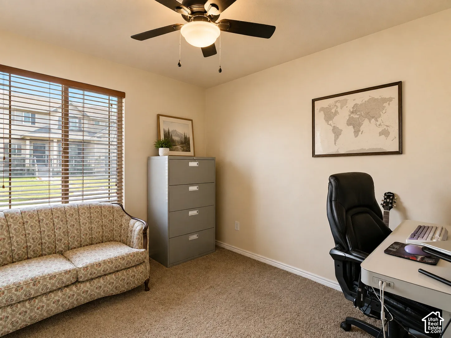 Recessed window with wood-tone blinds, neutral carpet, and a ceiling fan with integrated lighting