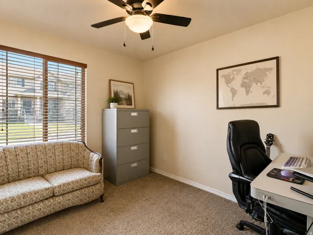 Recessed window with wood-tone blinds, neutral carpet, and a ceiling fan with integrated lighting