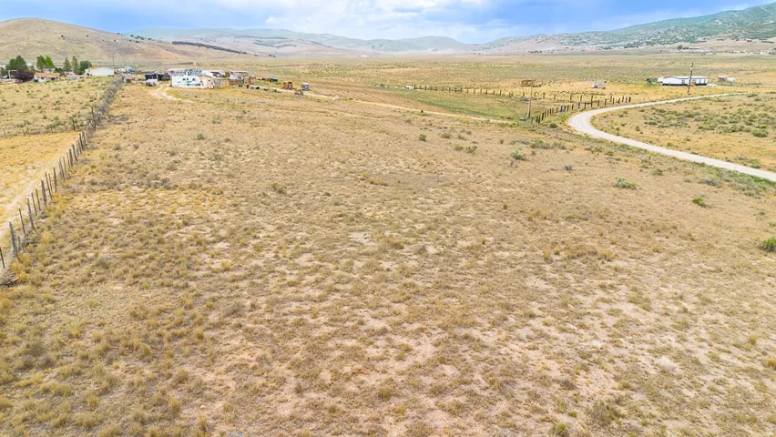 Expansive land parcel featuring natural vegetation and a distant mountain range