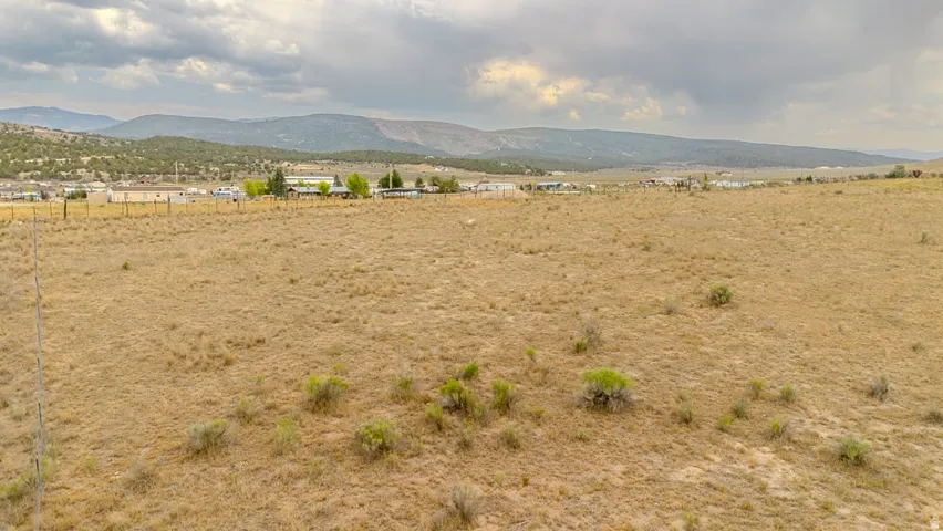 Expansive arid landscape with distant mountainous terrain