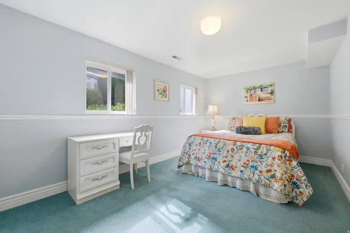Carpeted room featuring a single window, white baseboards, and chair rail molding