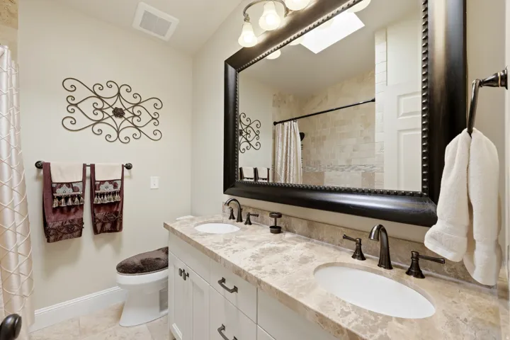 Dual vanity with integrated sinks and a stone countertop