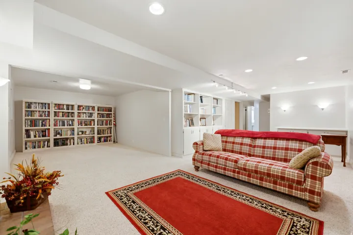Spacious room with recessed lighting and neutral carpeting