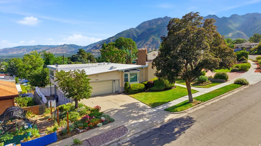 Contemporary-style residence with a two-car garage, featuring a flat roof and a stucco exterior