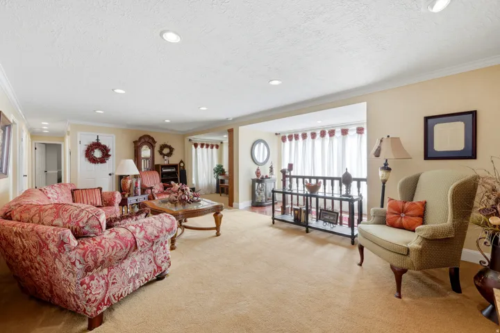 Spacious interior room featuring light-toned wall paint and crown molding