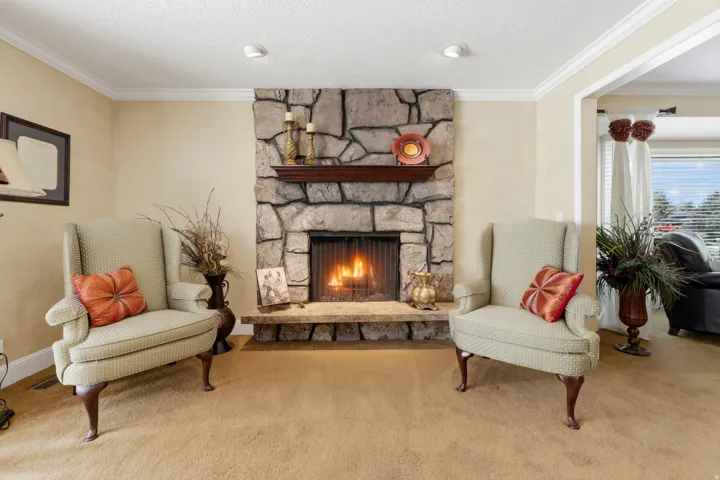 Stone-clad fireplace with a wood mantel and hearth