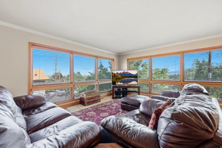 Living area featuring extensive window panels with wood-finish framing