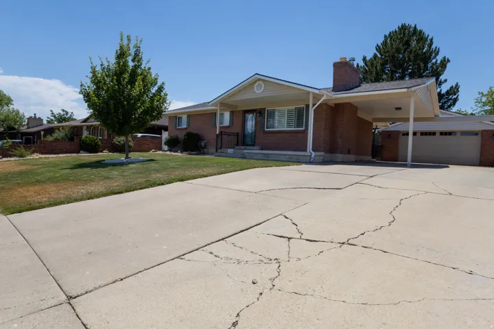 Brick exterior featuring a covered entry porch