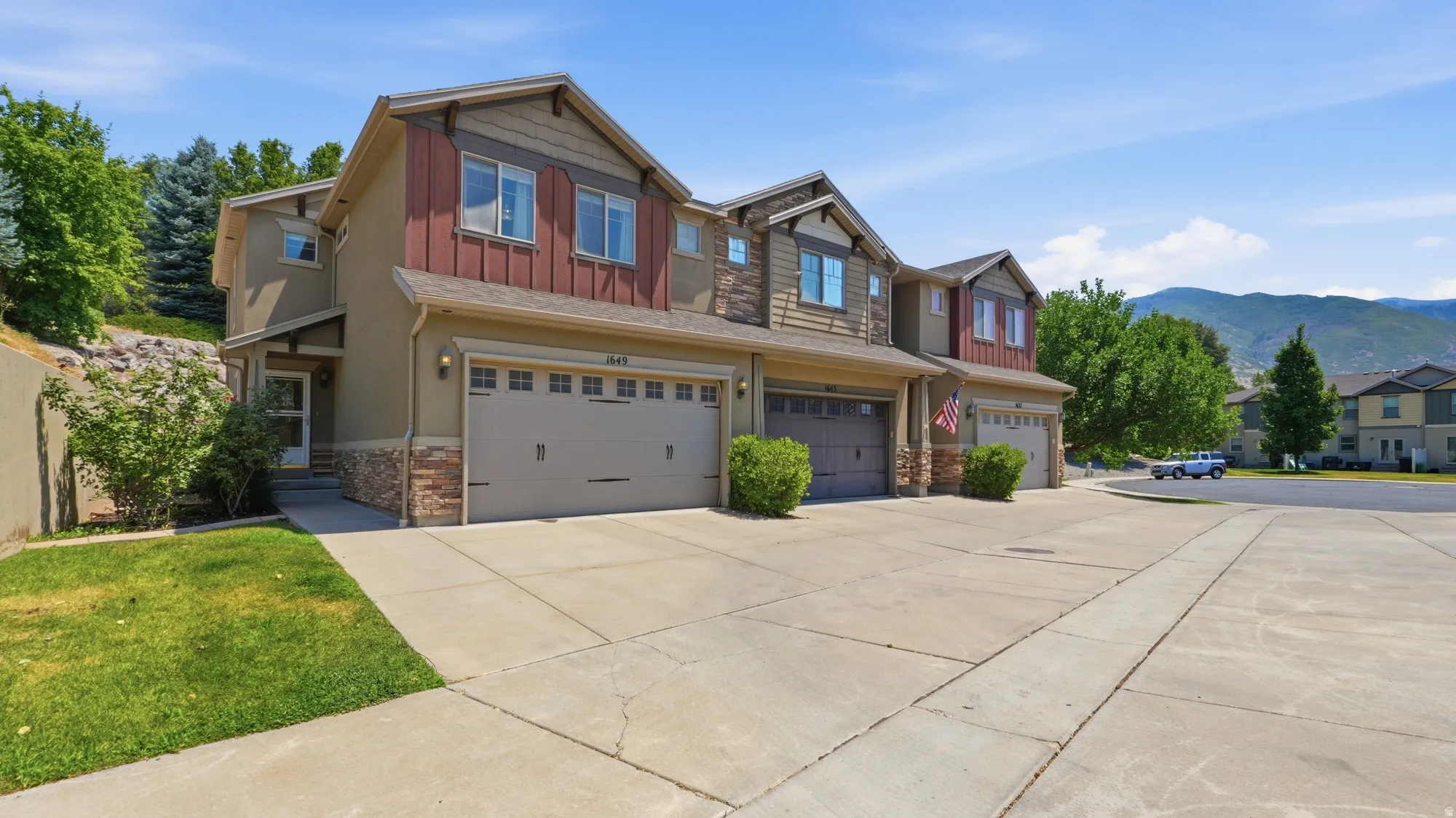 Multi-level exterior featuring stucco, horizontal siding, and stone veneer accents