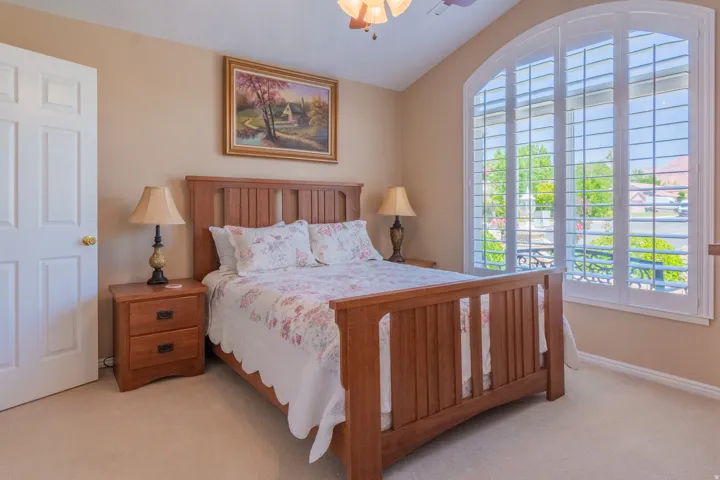 Arched window featuring plantation shutters