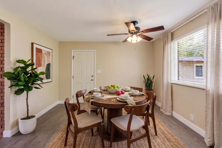 Dining area featuring wood-finish flooring and a ceiling fan