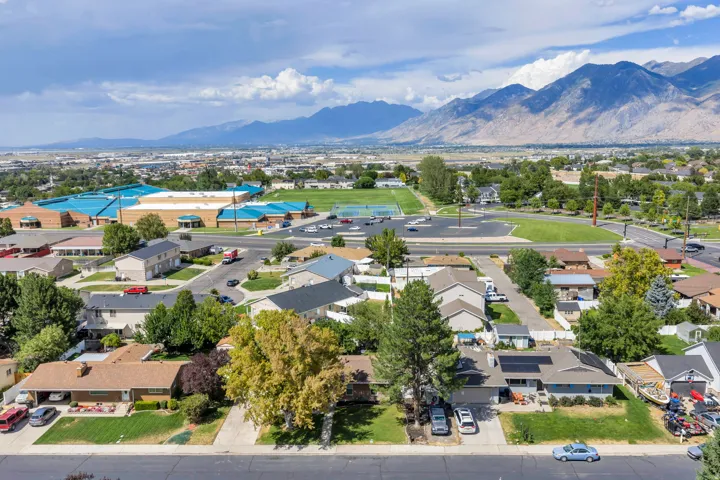 Neighborhood setting with mountain scenery, residential architecture, and verdant landscaping
