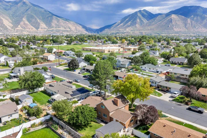 Aerial perspective of a residential neighborhood with surrounding mountains