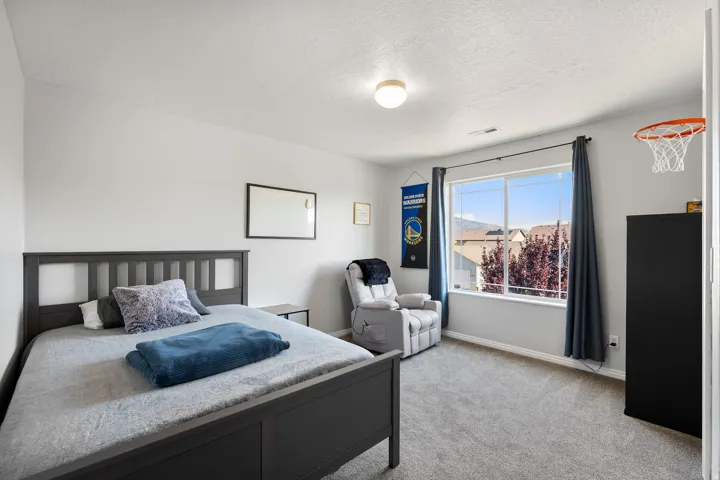 Spacious room featuring neutral paint, gray carpeting, a large window, and a flush mount ceiling light