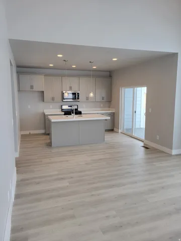 Open-concept kitchen featuring an island, recessed lighting, and pendant fixtures