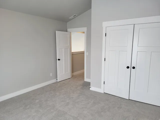 Light gray carpeting with white baseboards