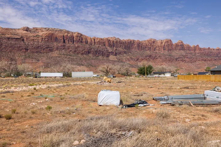 Expansive undeveloped land featuring a prominent red rock mountain backdrop