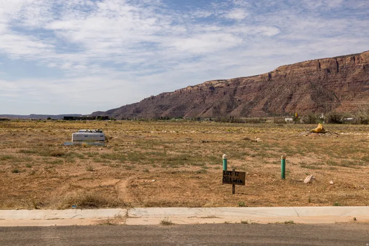 Expansive undeveloped lot featuring natural desert landscaping and a distant mountain backdrop