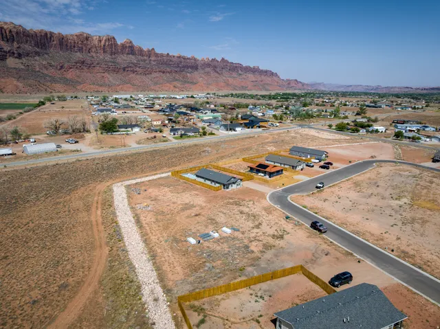 Aerial perspective showcasing residential properties with a mountainous backdrop
