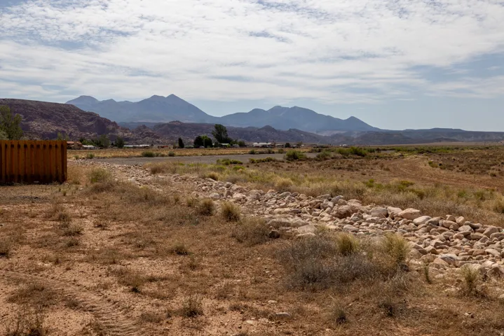 Expansive desert landscape featuring distant mountains and a clear sky