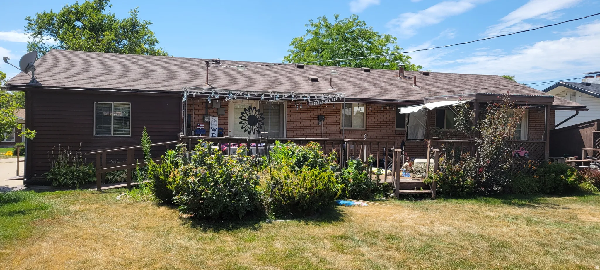 Rear elevation featuring wood siding and brick veneer