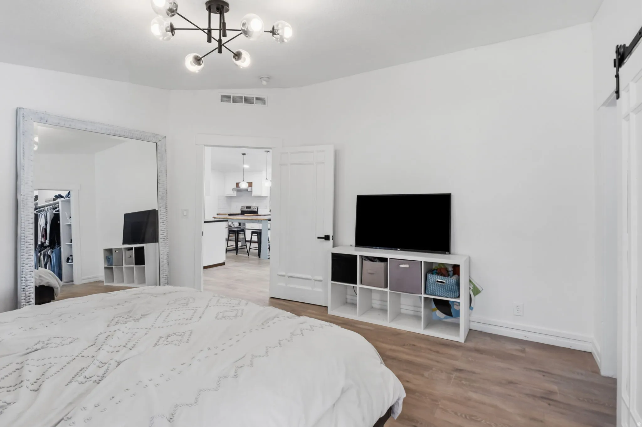 Light wood-finish flooring complements bright white walls throughout this space