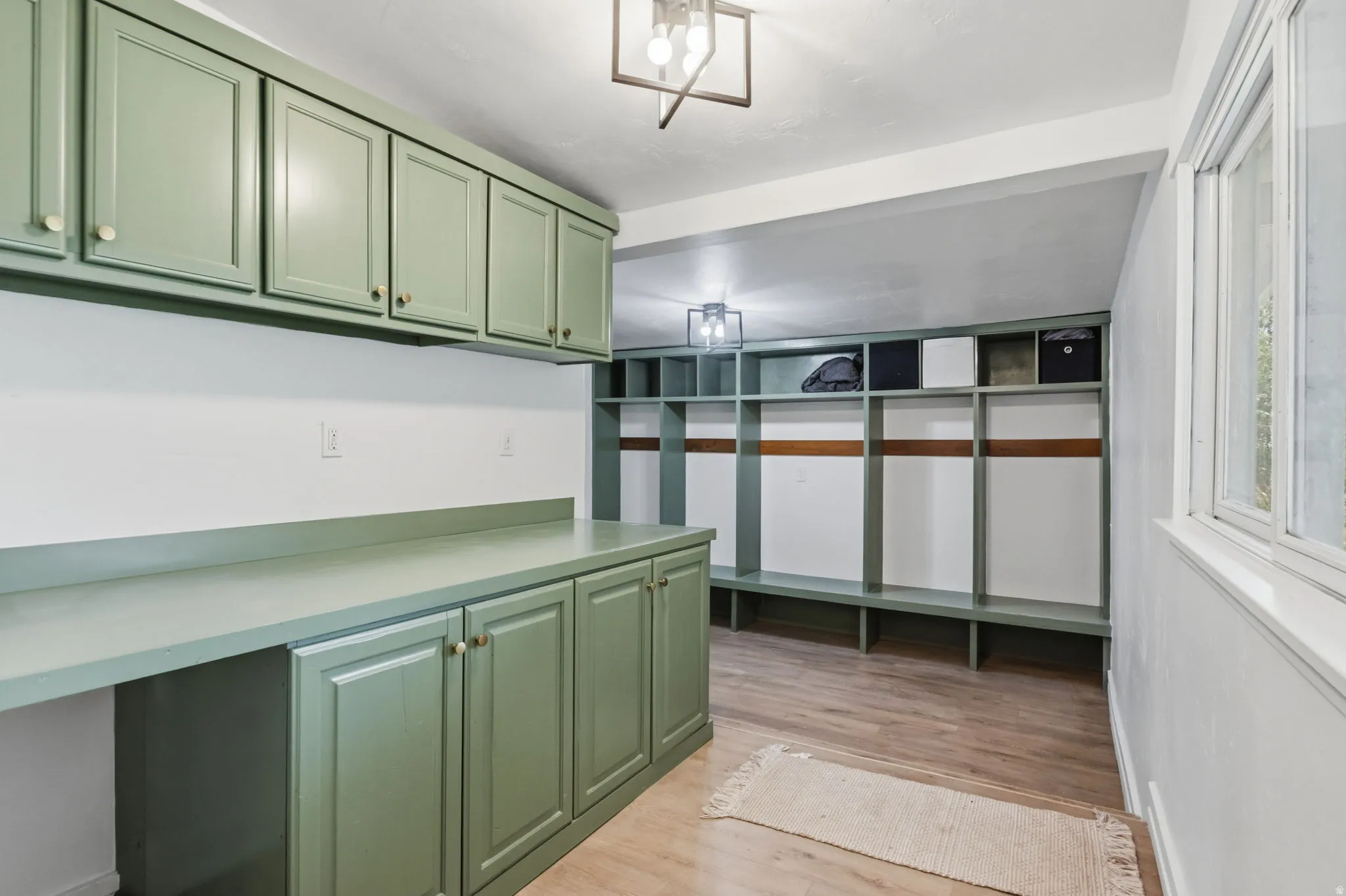 Mudroom featuring built-in cabinetry, extensive counter space, and integrated cubby storage