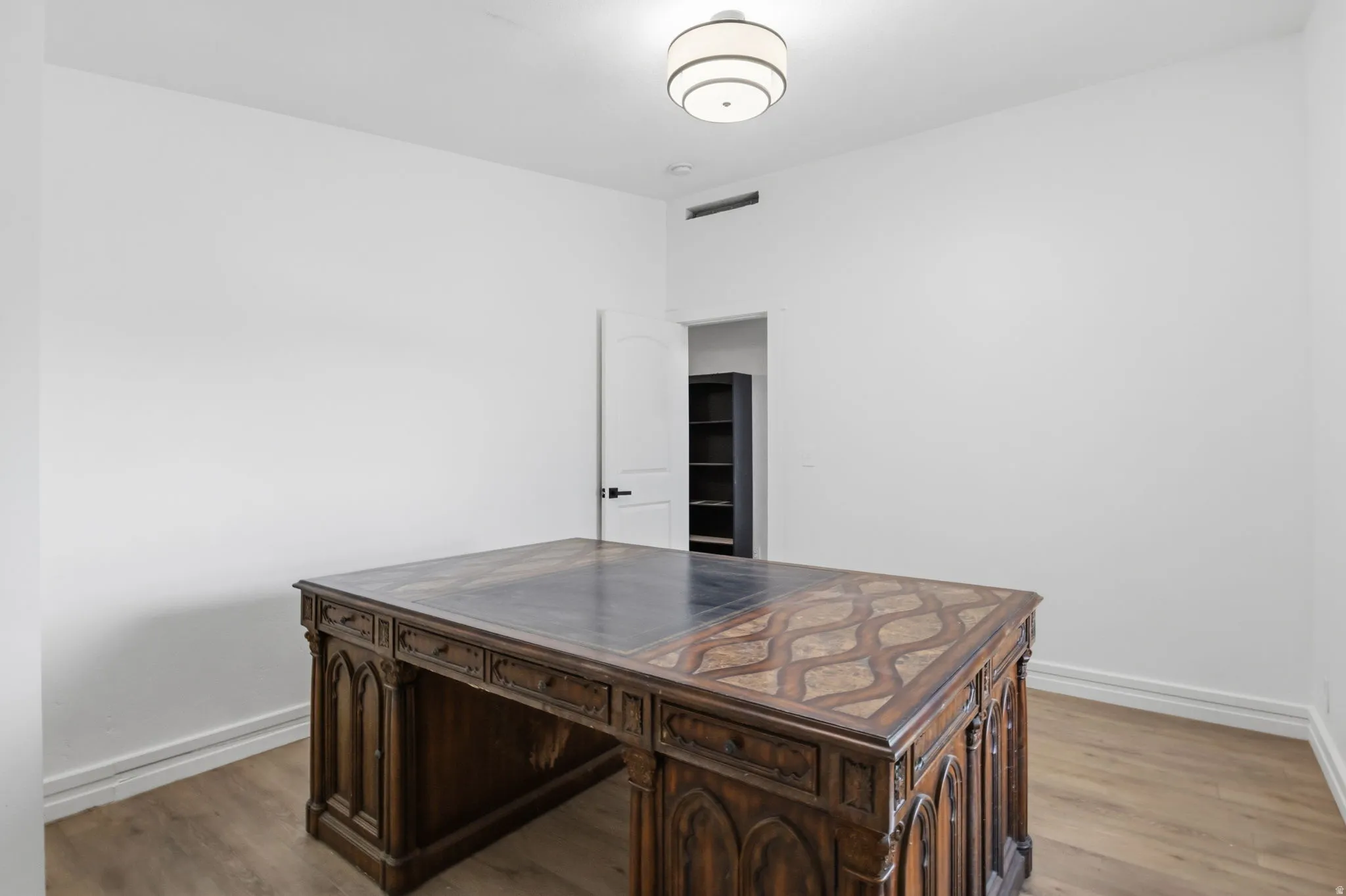 Spacious room with light wood-finish flooring
