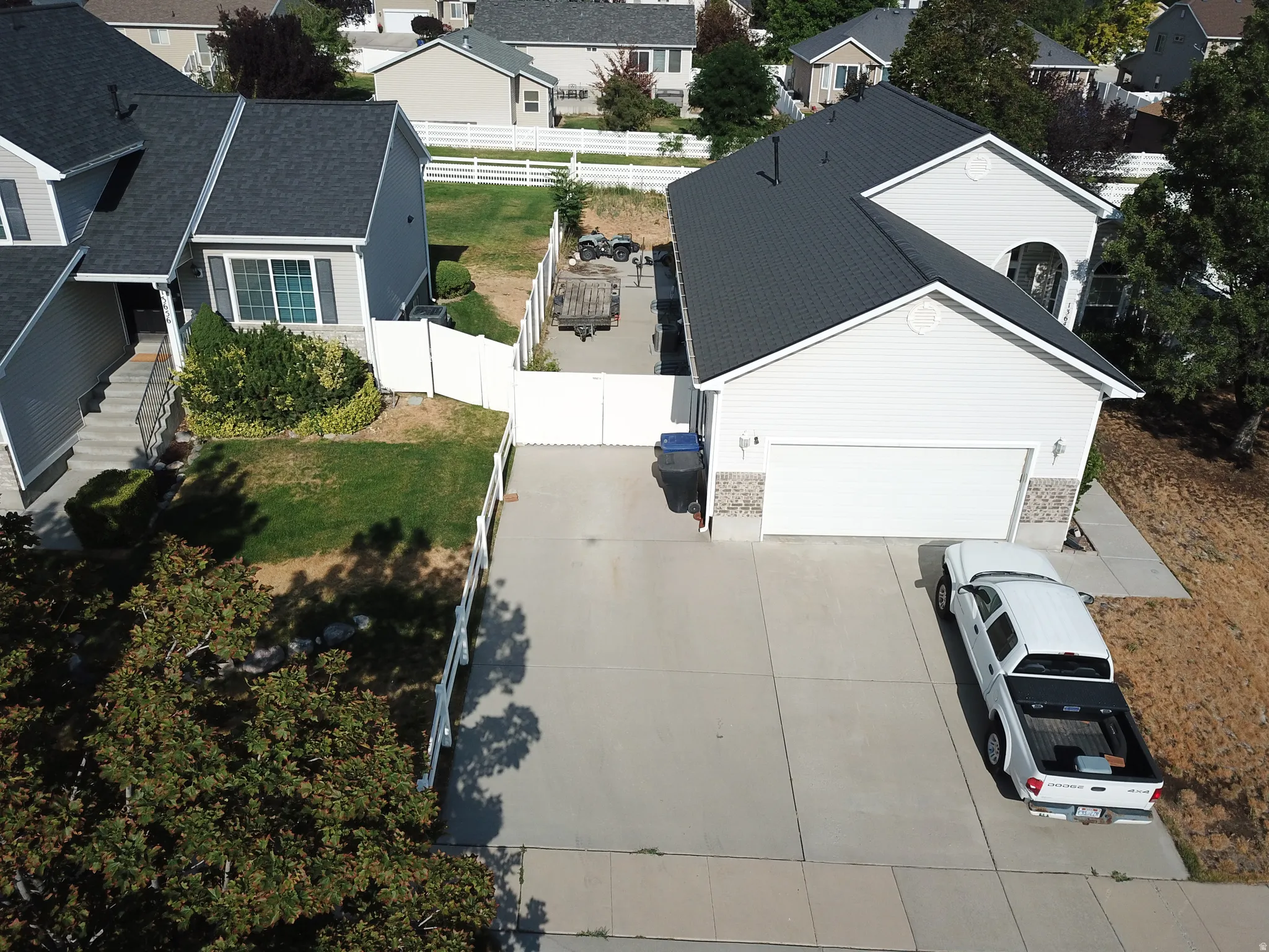 Two-story residence featuring a two-car garage with stone veneer accents and a concrete driveway