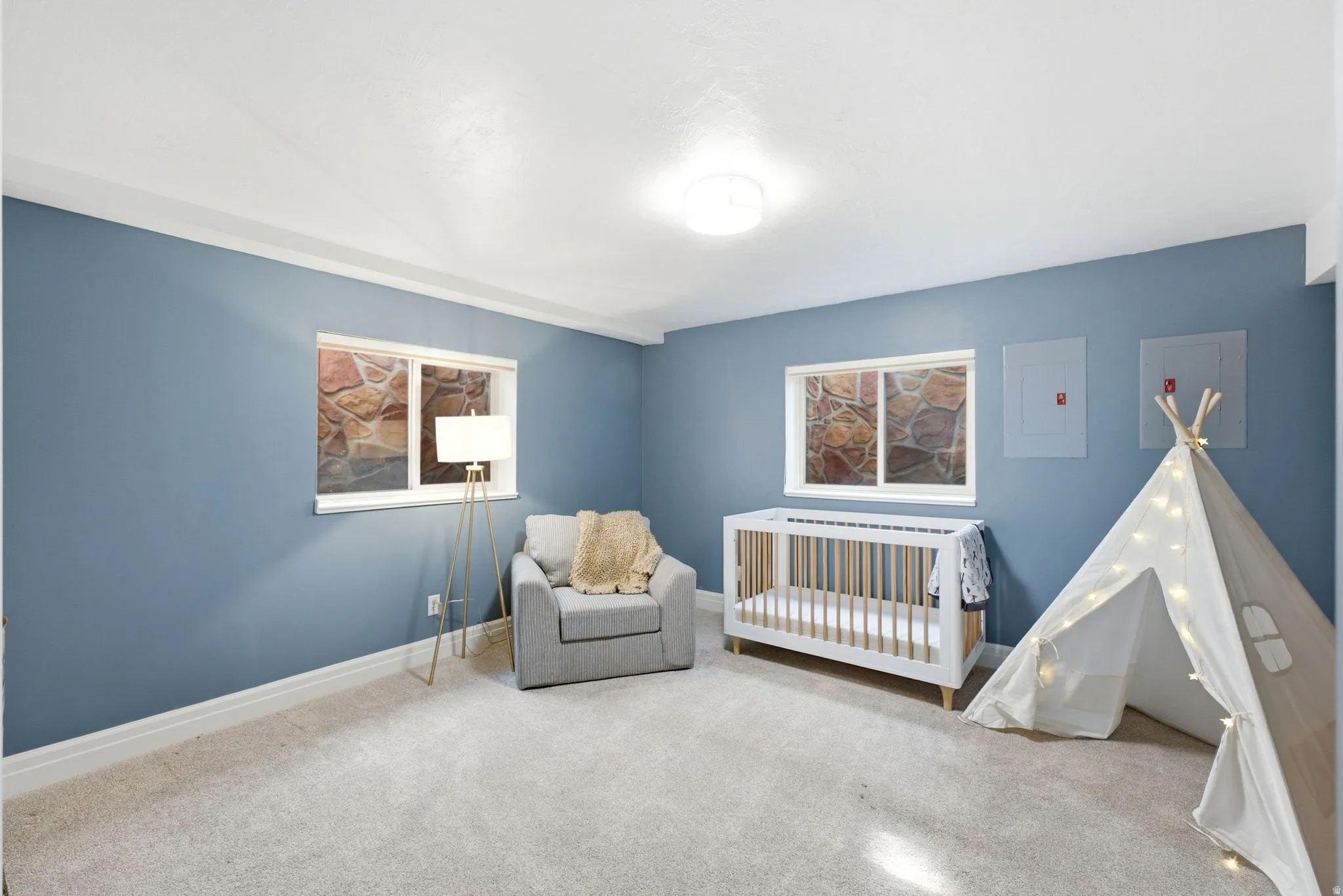 Carpeted room with blue walls and white trim