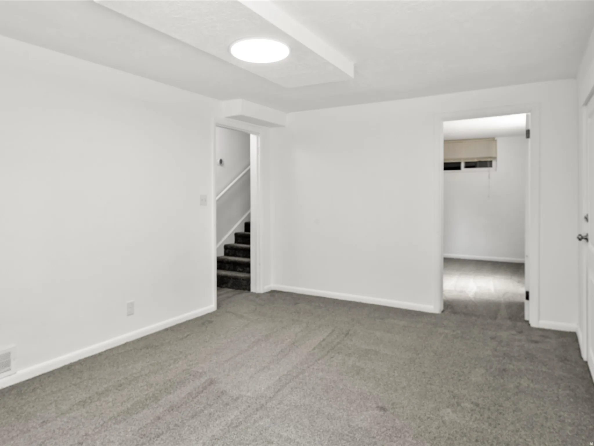 Room featuring neutral gray carpeting and white painted walls