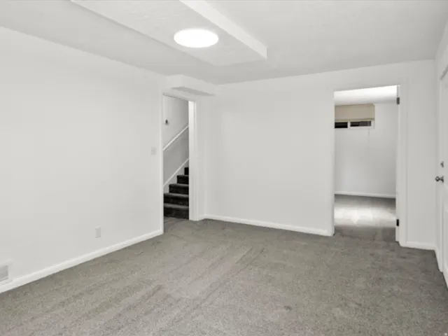 Room featuring neutral gray carpeting and white painted walls