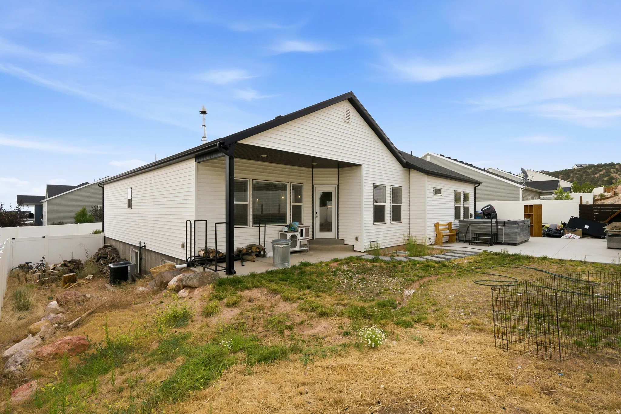 Rear exterior featuring a covered patio, white siding, and a gabled roofline
