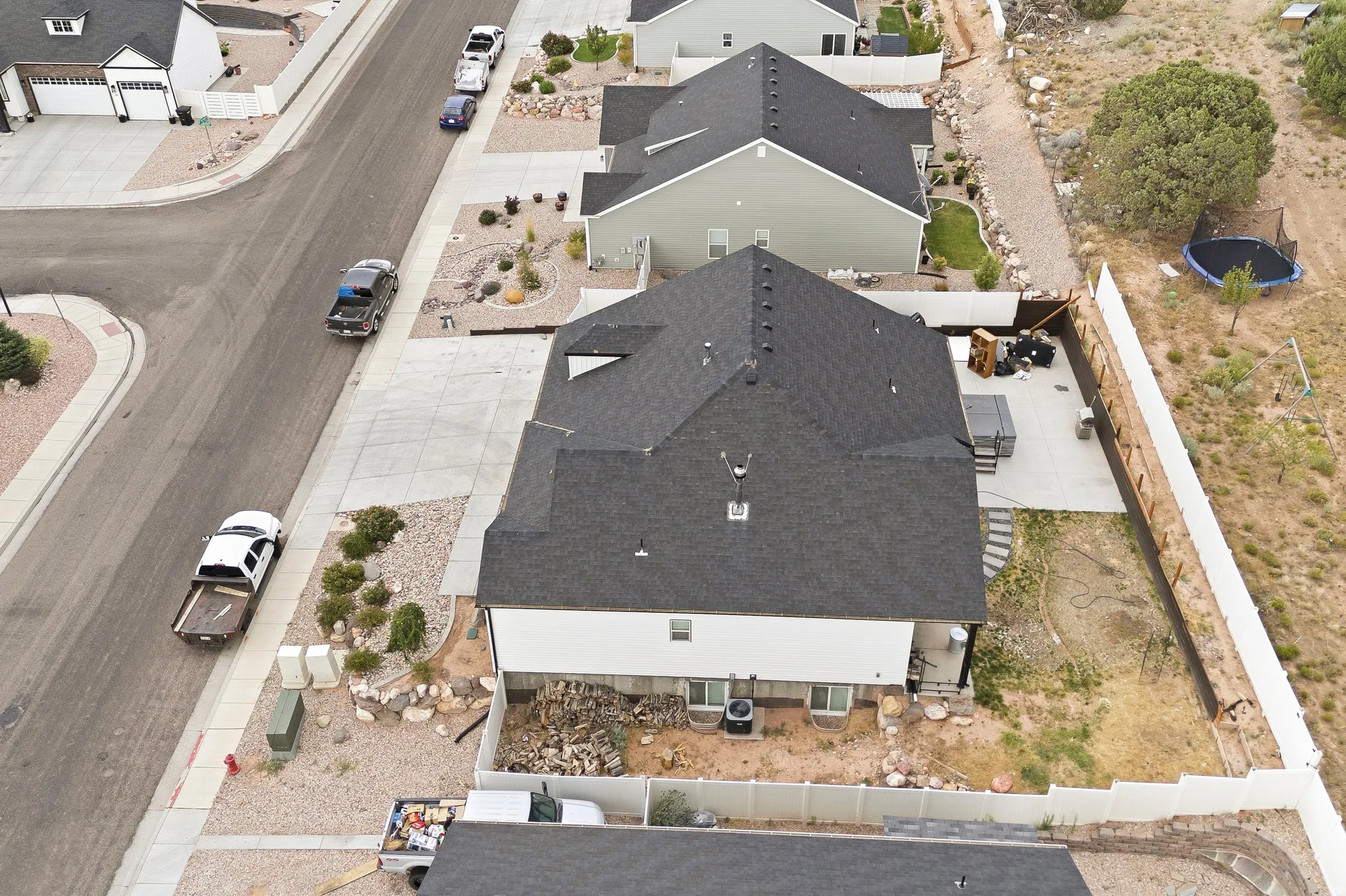 New construction residence featuring a dark shingle roof and light-colored siding
