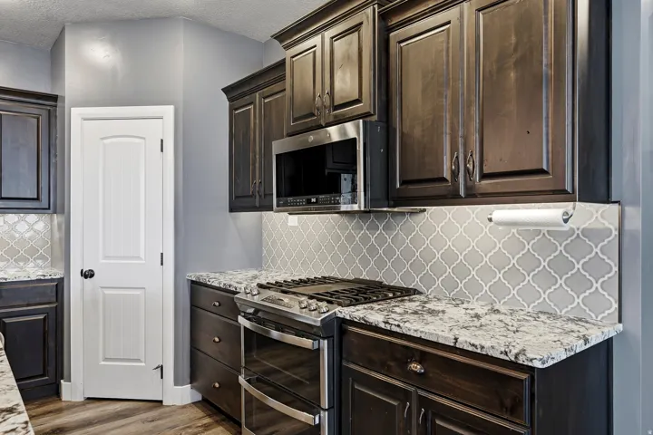 Kitchen featuring dark wood cabinetry and light-colored countertops