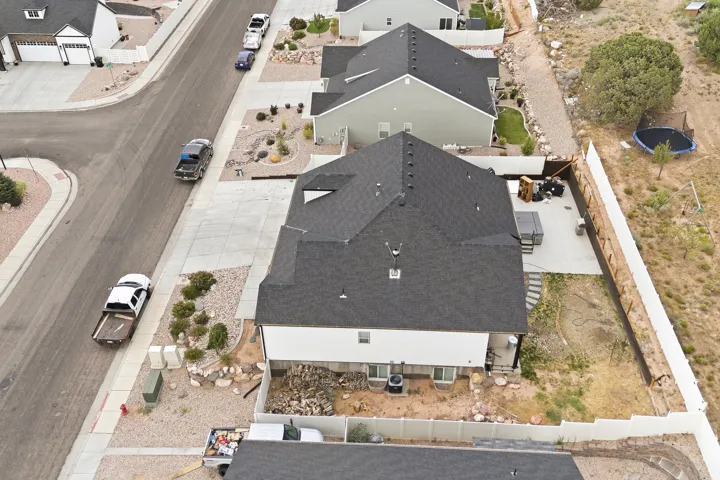 New construction residence featuring a dark shingle roof and light-colored siding