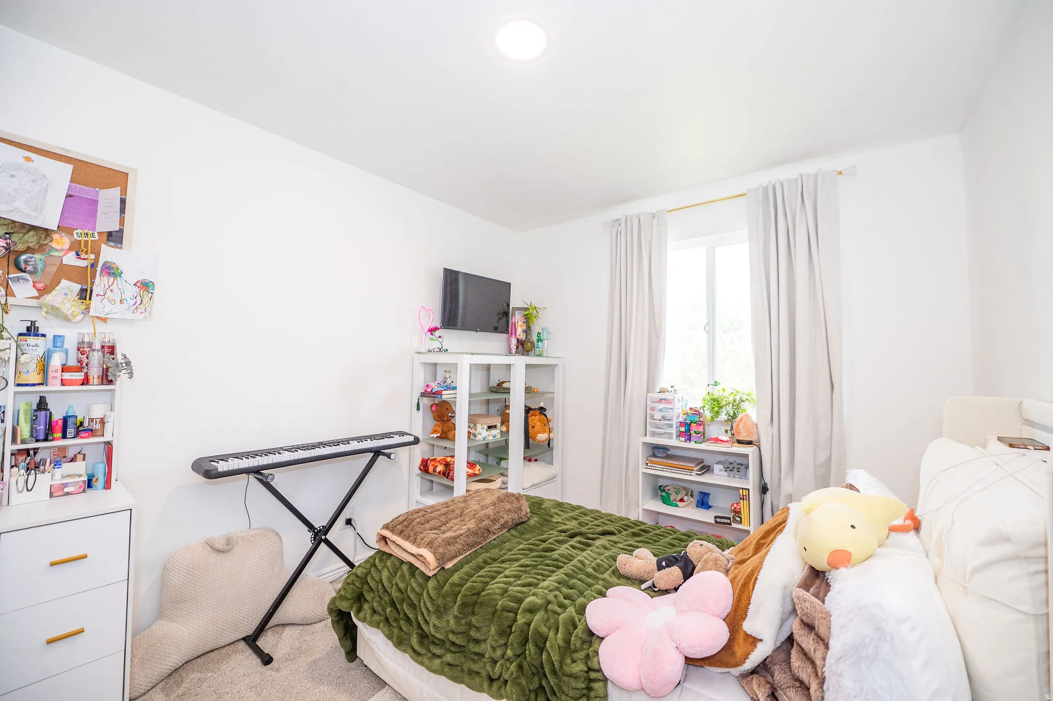Bright interior space featuring a window with white trim, recessed ceiling lighting, and light-toned walls