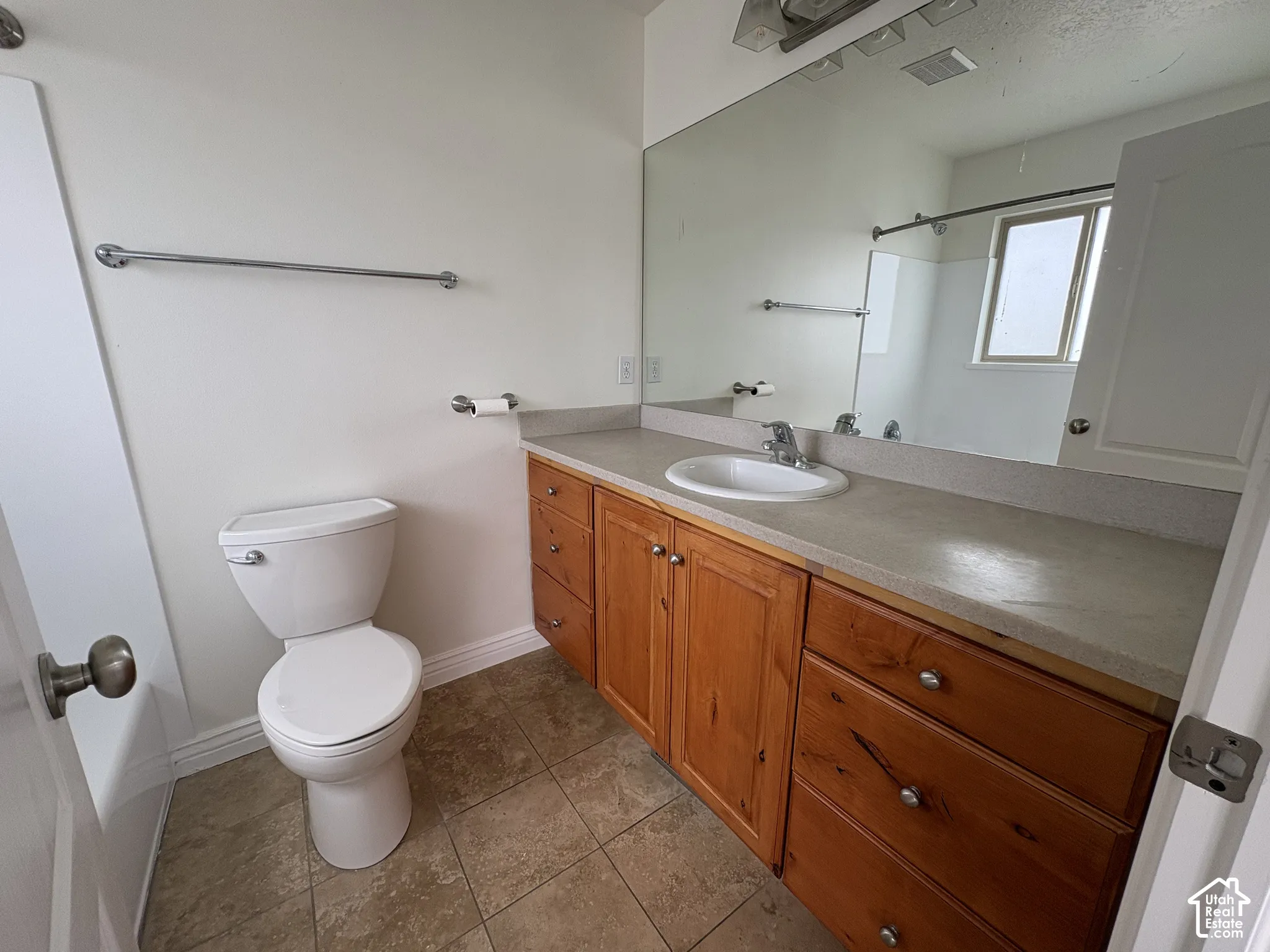 Master Bathroom featuring a single vanity with wood cabinetry, a light-toned countertop, and an integrated sink