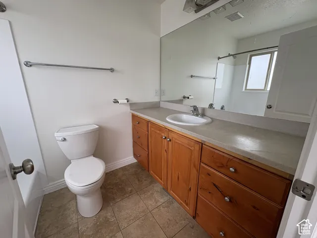 Master Bathroom featuring a single vanity with wood cabinetry, a light-toned countertop, and an integrated sink