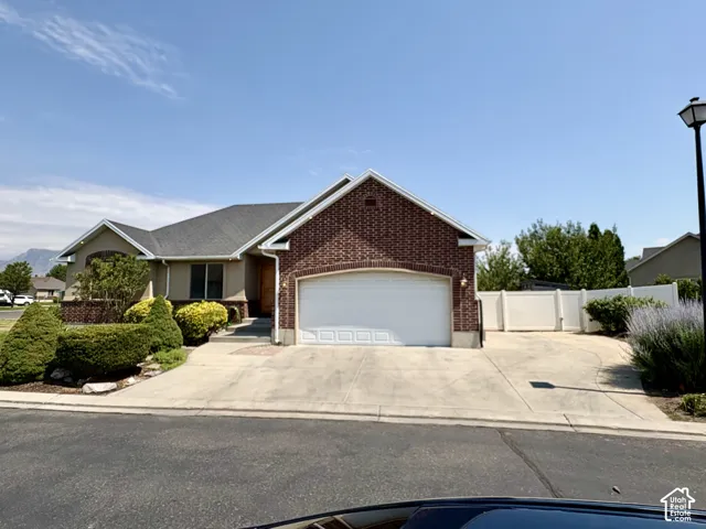 Brick and stucco exterior featuring a two-car garage