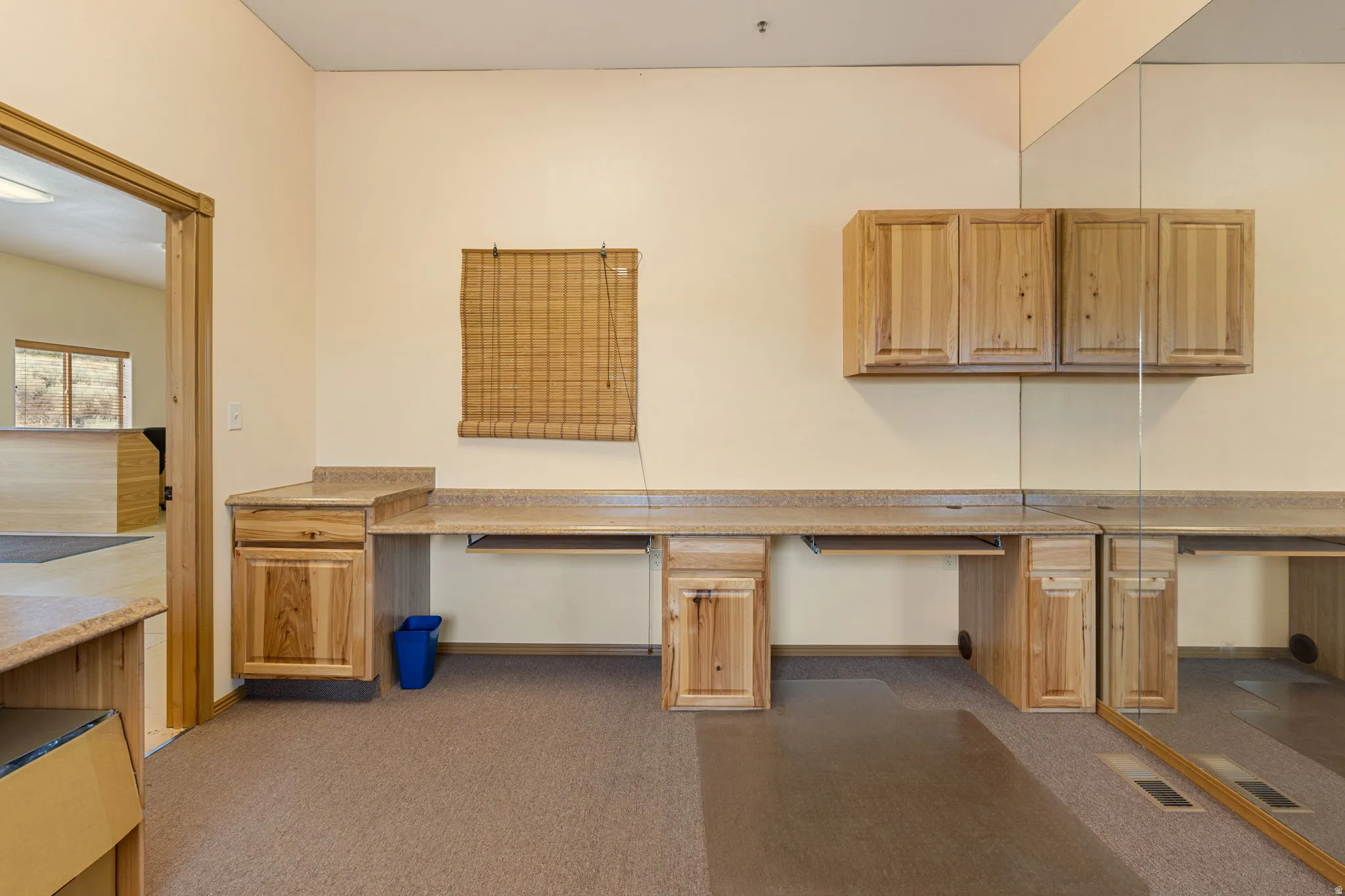 Built-in desk cabinetry with integrated countertops and overhead storage