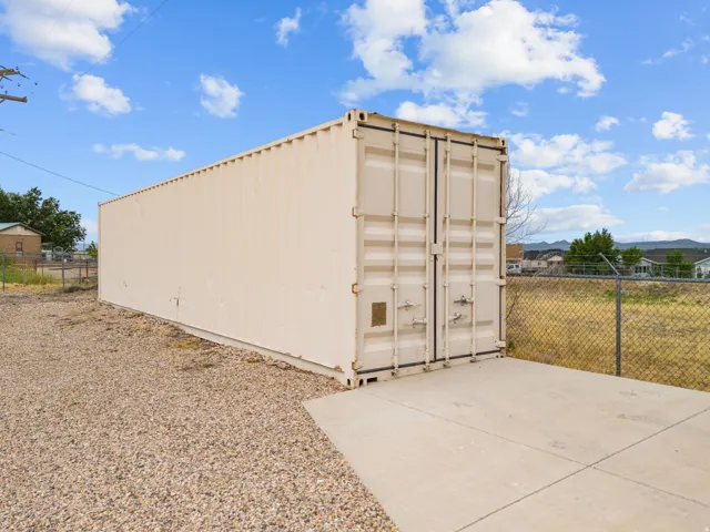 Exterior storage container with rear access doors