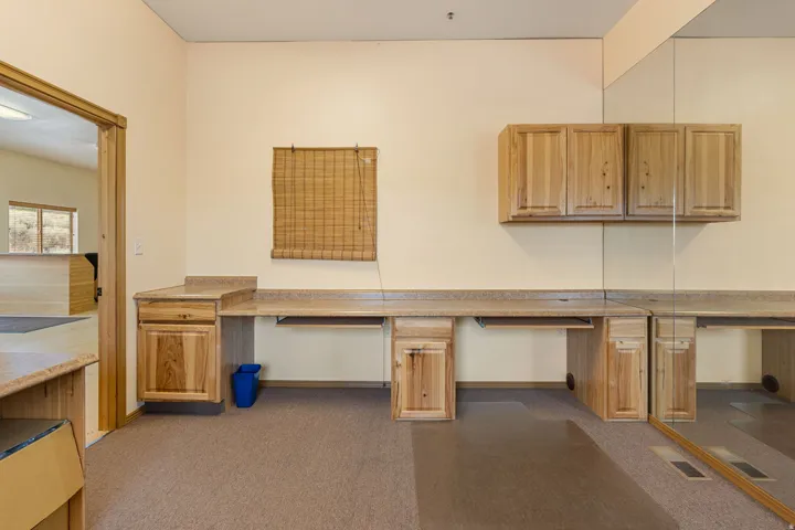Built-in desk cabinetry with integrated countertops and overhead storage
