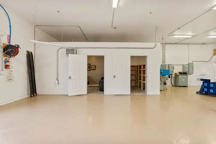 Spacious interior with light-toned flooring and white walls