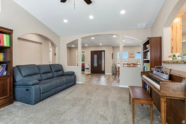 Carpeted living area featuring recessed lighting and a ceiling fan