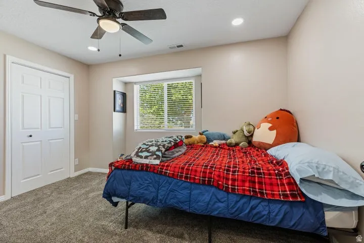 Room featuring a ceiling fan with integrated lighting, recessed lighting, and a window with blinds