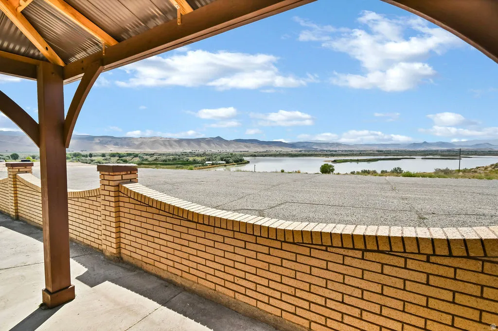 Covered patio area with a corrugated metal roof and exposed wood beams