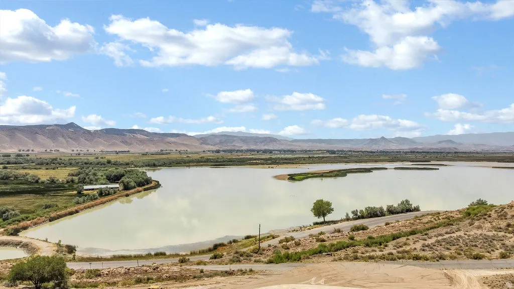 Expansive water feature with natural shoreline and distant mountain range